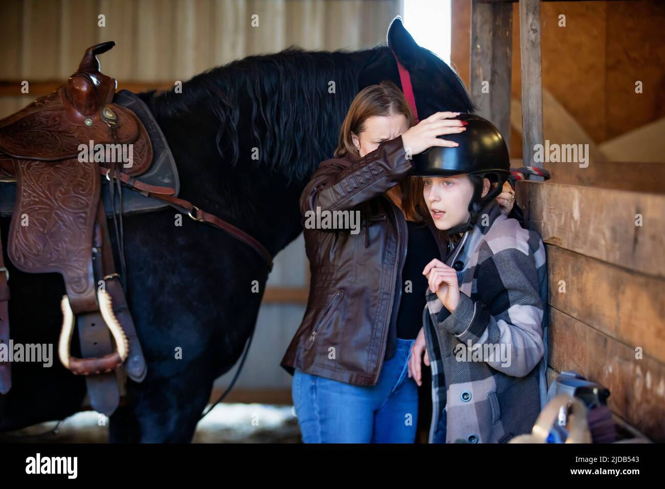 A young girl with Cerebral Palsy and her mom getting ready for a Hippotherapy session with the horse; Westlock, Alberta, Canada Stock Photo
