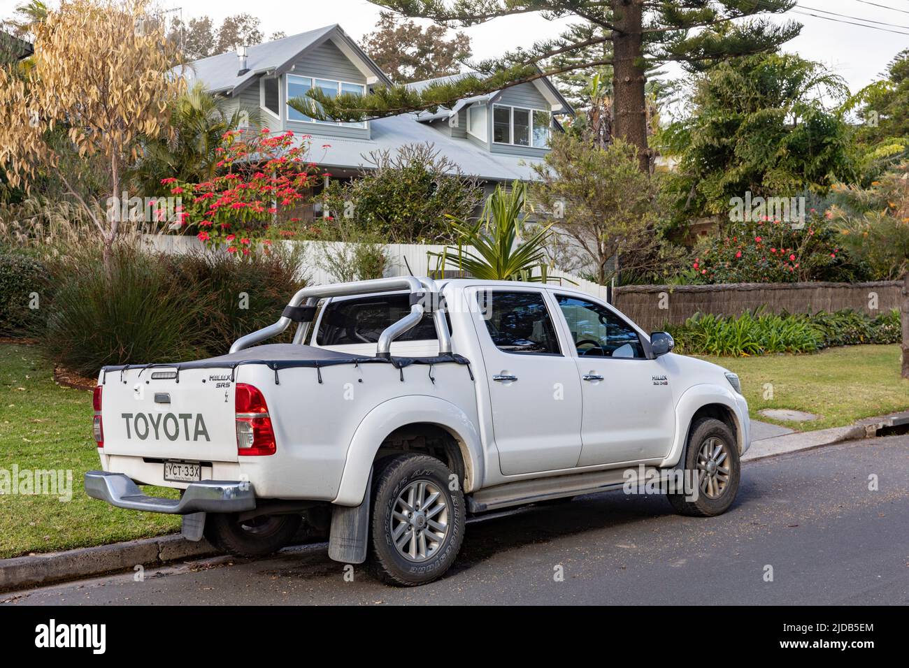 2014 model white Toyota Hilux ute utility vehicle parked in Avalon Beach street road,Sydney,NSW,Australia Stock Photo