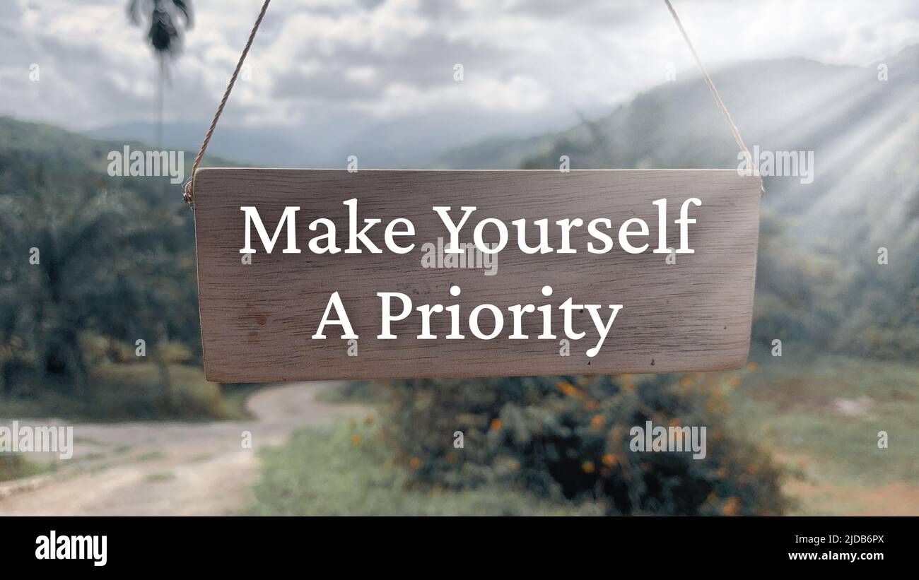 Inspirational quote text on wooden banner with nature background - Make yourself a priority. Inspirational concept Stock Photo