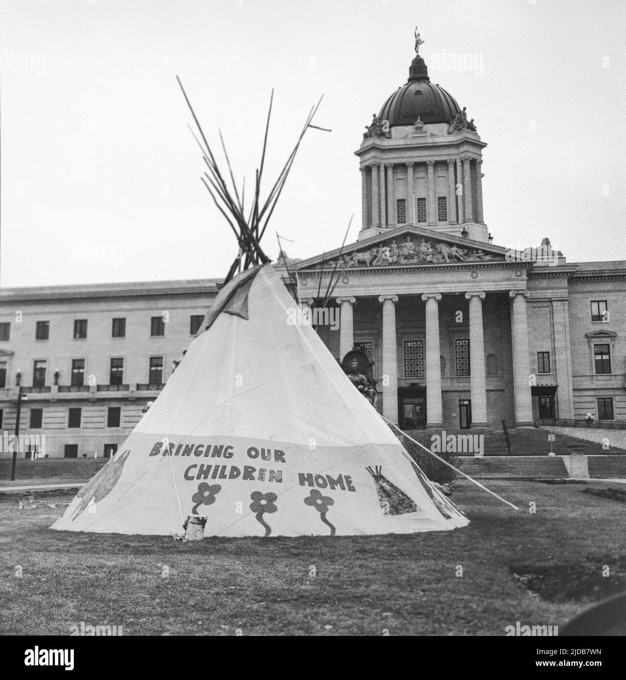 Teepee with the inscription 'Bringing Our Children Home' on the Manitoba Legistlative Grounds; Winnipeg, Manitoba, Canada Stock Photo