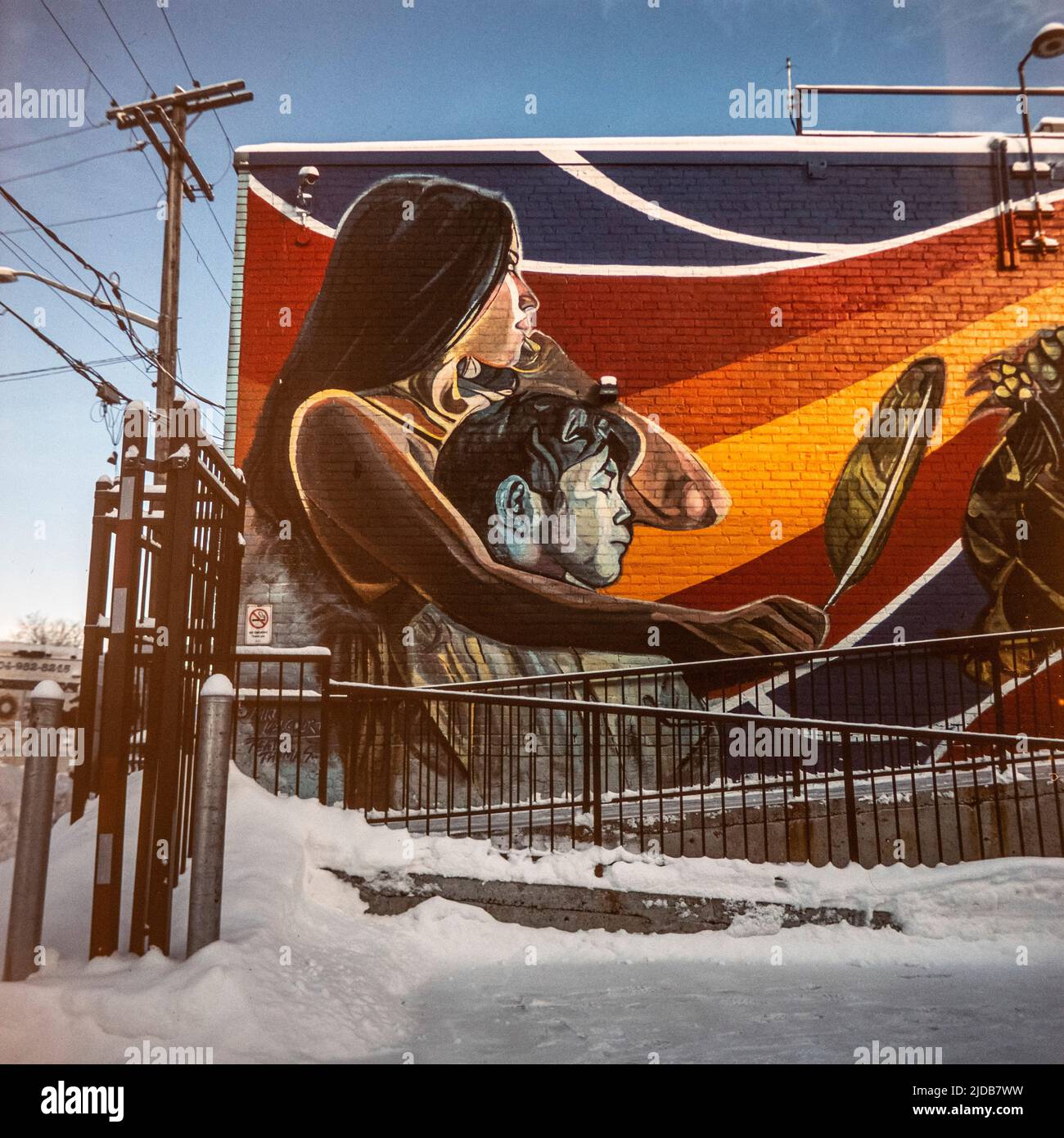 Painted mural on brick building wall in Canadian Indigenous theme and
