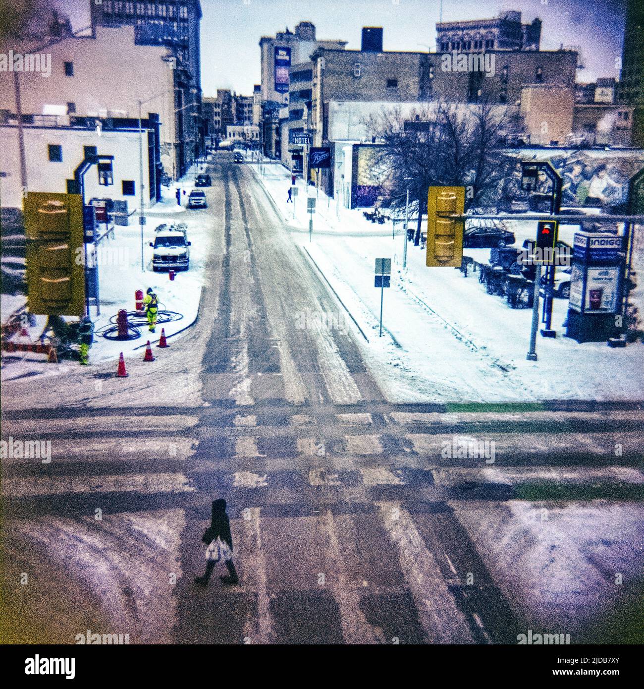 Street scene in winter with tire tracks going down streets and through