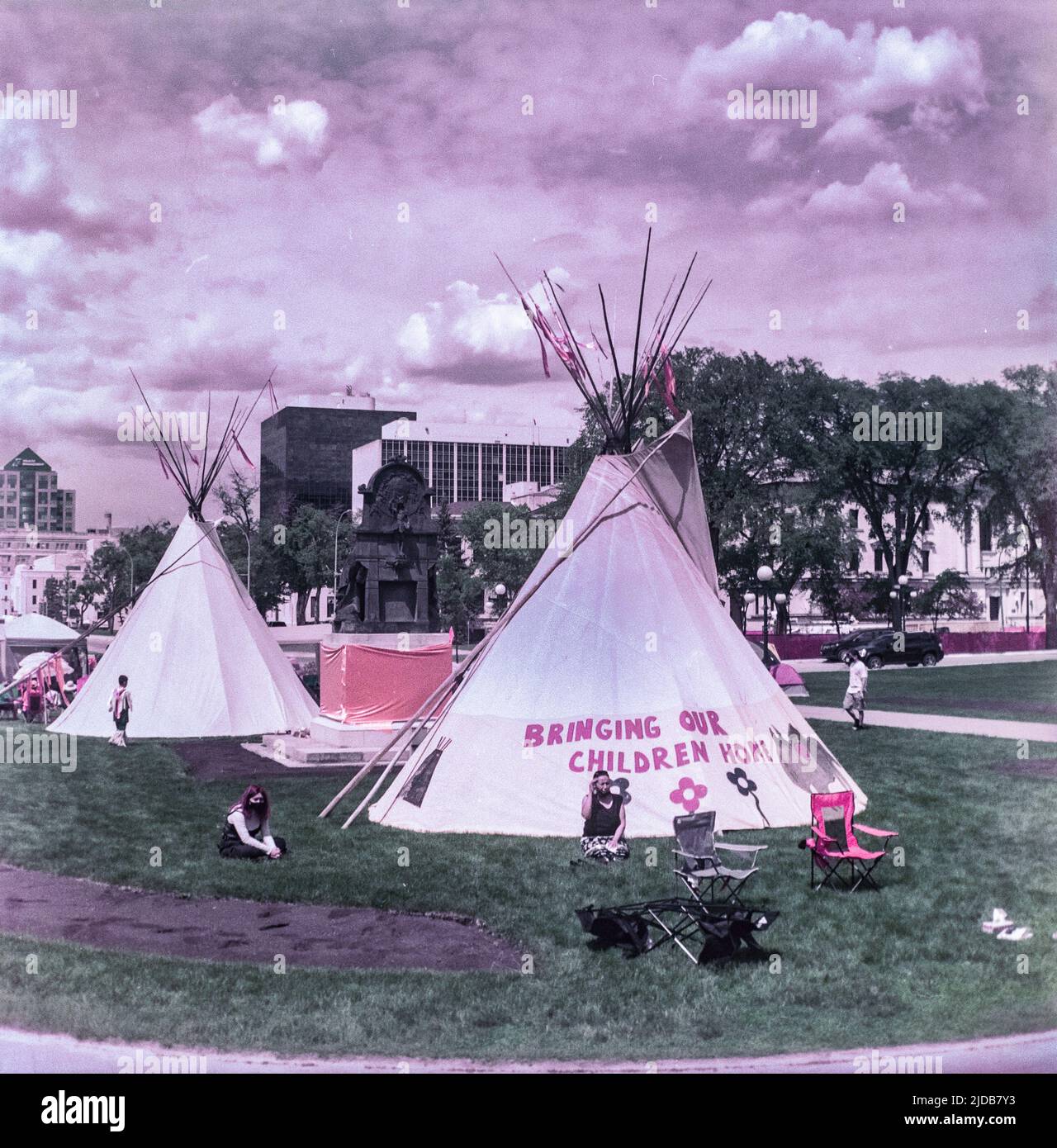 Teepees with the inscription 'Bringing Our Children Home' on the Manitoba Legistlative Grounds; Winnipeg, Manitoba, Canada Stock Photo