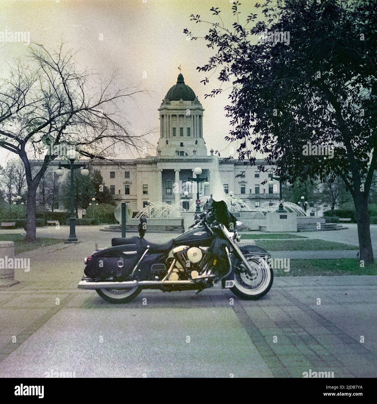 Motorcycle parked in front of the Manitoba Legislative Building; Winnipeg, Manitoba, Canada Stock Photo