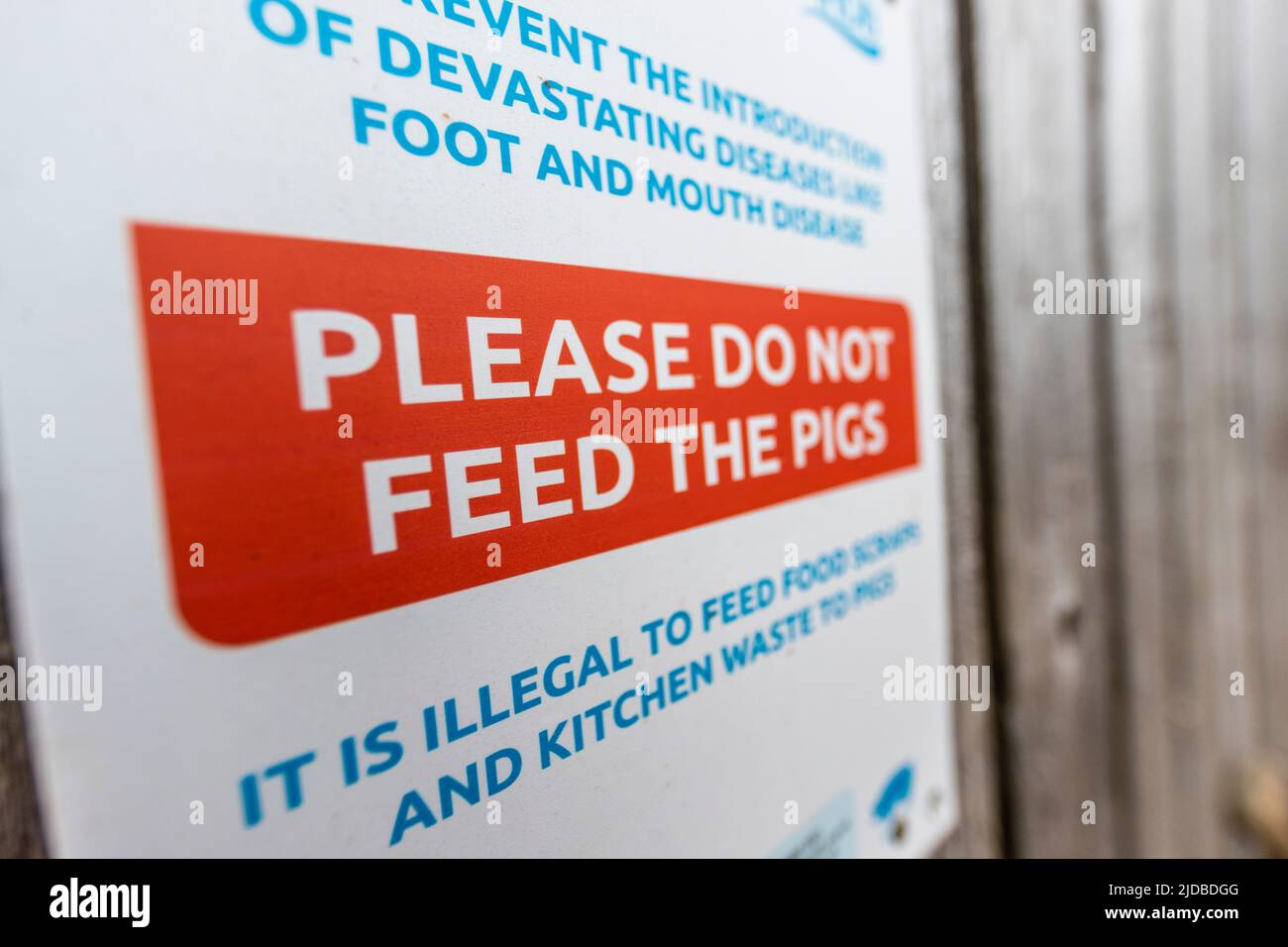 Do not feed the pigs sign on a farm partially open to the public