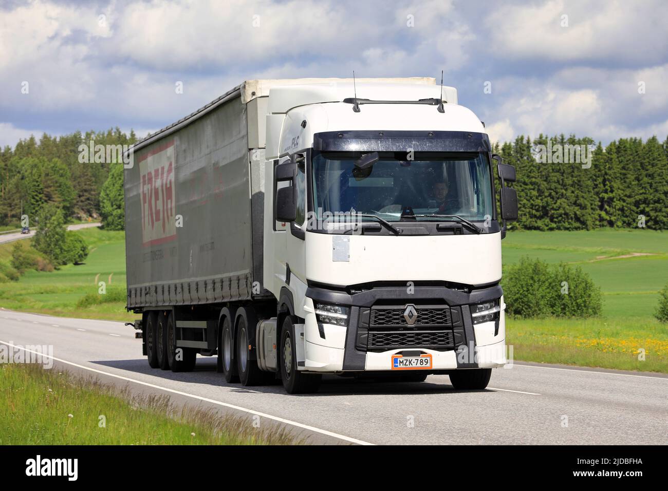 New, white Renault trucks T Evolution pulls trailer along highway 52 on a day of summer. Salo, Finland. June 9, 2022. Stock Photo