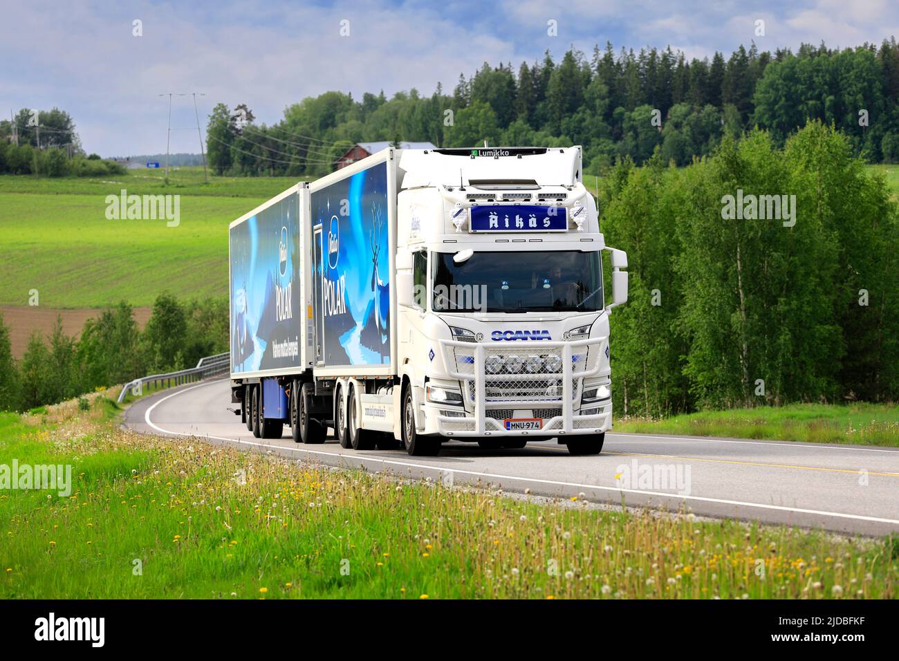 White customised Scania truck Kuljetus Äikäs Oy pulls Lumikko temperature controlled trailer on road in the summer. Salo, Finland. June 11, 2022. Stock Photo