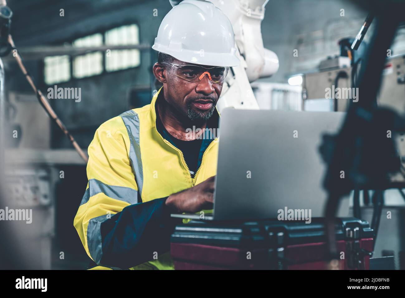 Factory worker working with laptop computer to do adept procedure checklist . Factory production line operator occupation quality control concept . Stock Photo