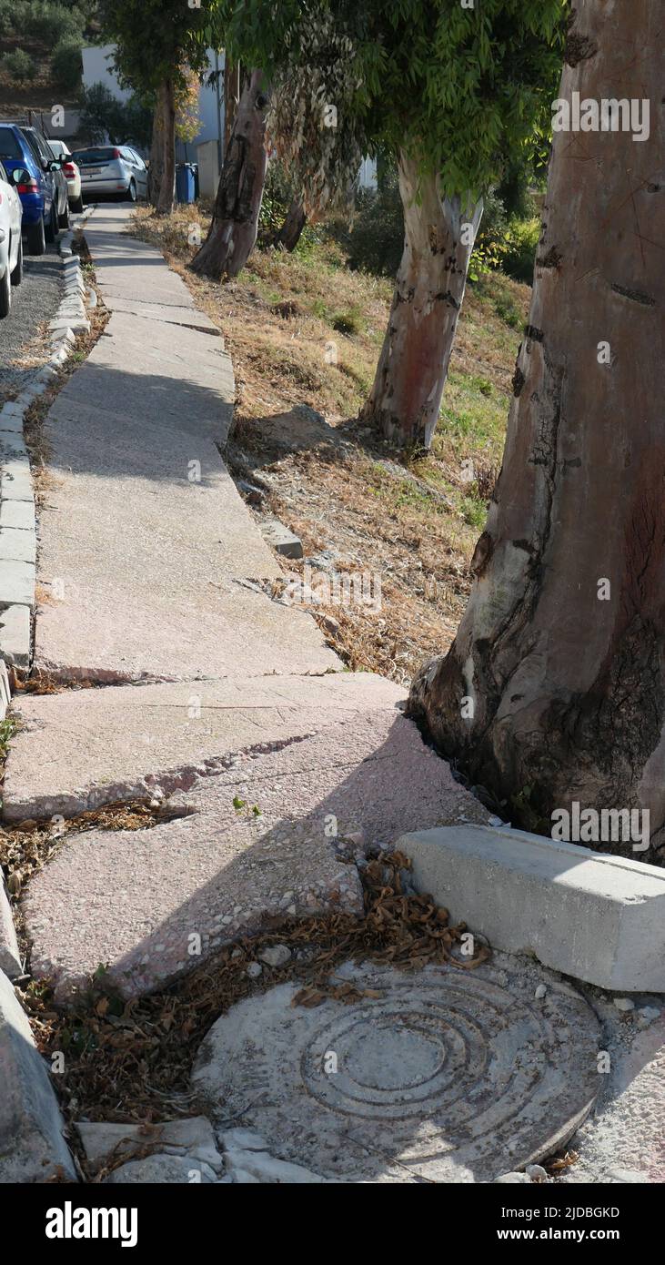Broken Pavement Slabs on street in village in Andalusia Stock Photo