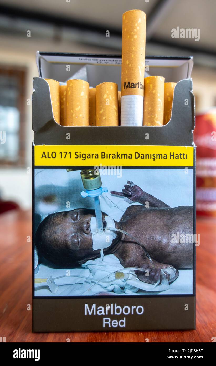 marlboro red - Turkish edition - pack of cigarettes. opened . Warning on a cigarette pack showing sick dying black baby Stock Photo