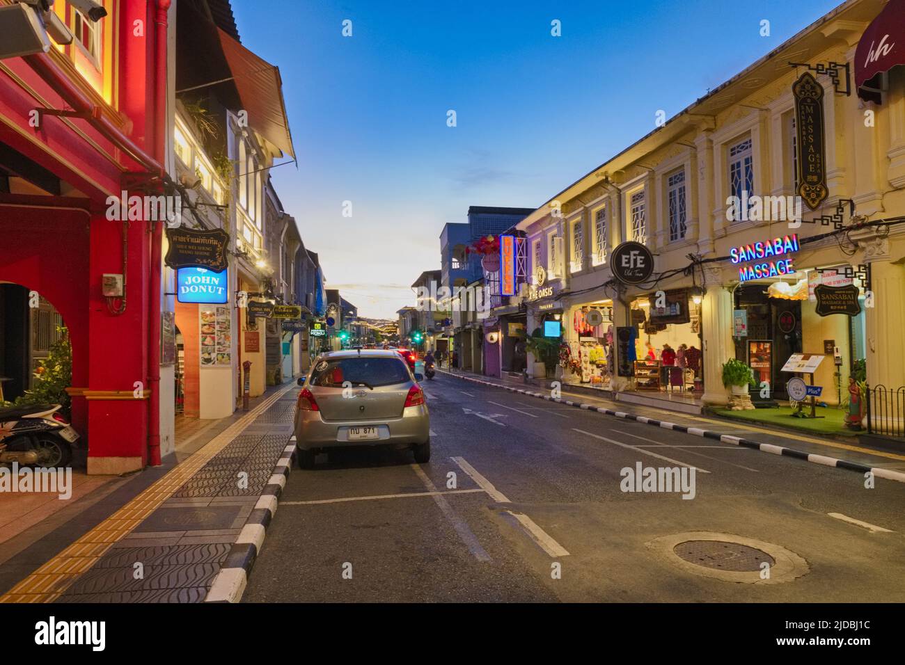 Dusk falls on the picturesque Sino-Portuguese or Peranakan shophouses in Thalang Road in the Old Town heritage area of Phuket Town, Phuket, Thailand Stock Photo