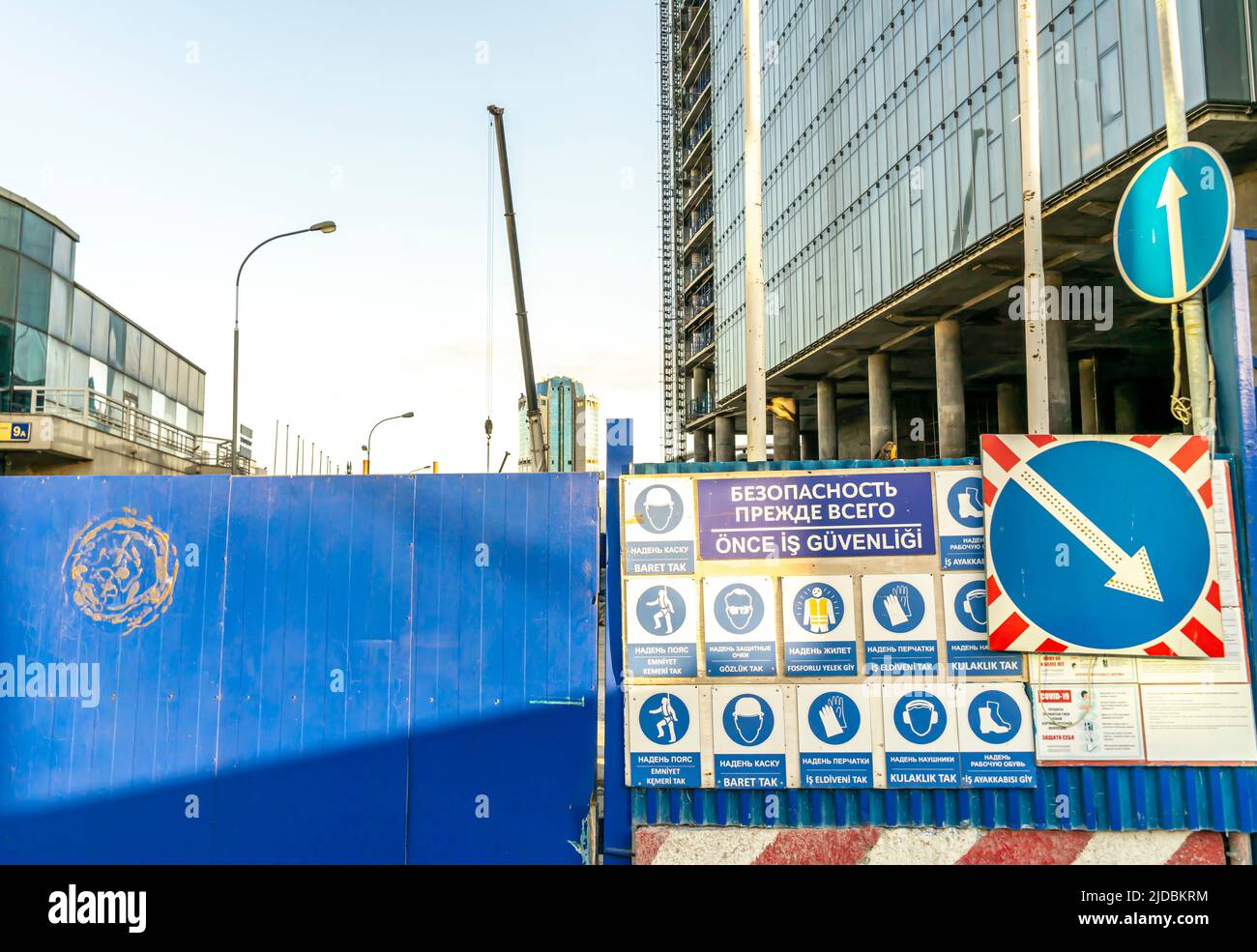 Construction safety signs rules at the fence of the construction site in Moscow, russia - in Turkish and Russian Stock Photo