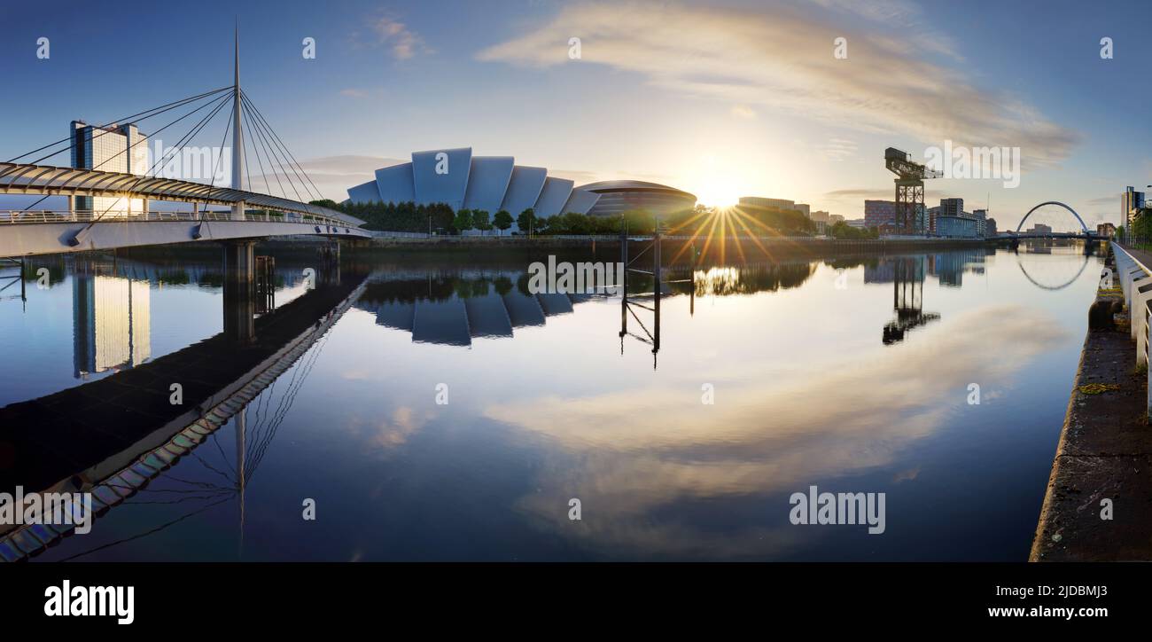 Glasgow Cityscape at sunrise, skyline panorama with reflecion in river with sun, Scotland - UK Stock Photo