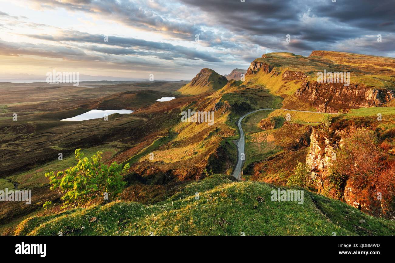 Scotland - Beautiful summer sunrise mountain landscape over the Quiraing and it's steep winding mountain road, on the Isle of Skye, UK Stock Photo