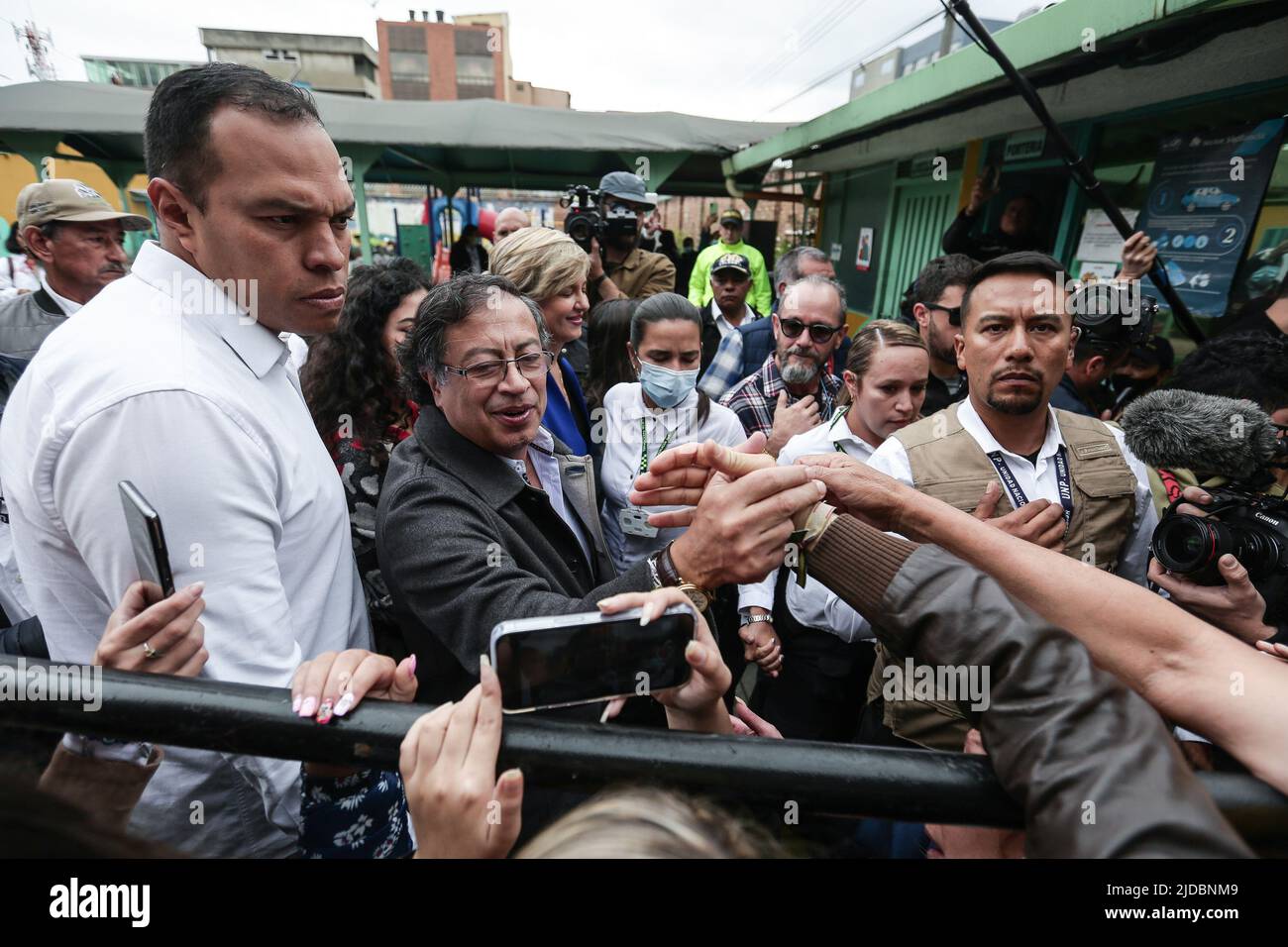 Bogota, Colombia. 19th June, 2022. Gustavo Petro (2nd L front), presidential candidate of the leftist Historic Pact for Colombia coalition, shakes hands with supporters at a polling station in Bogota, Colombia, June 19, 2022. Gustavo Petro was elected president of Colombia on Sunday after defeating independent candidate Rodolfo Hernandez in the second round of elections in a very close race, the state-run National Civil Registry reported. Credit: Jhon Heaver Paz/Xinhua/Alamy Live News Stock Photo