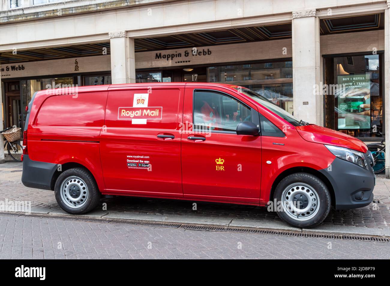 A modern, red, Royal Mail postal van parked in a retail area, Cambridge, UK Stock Photo
