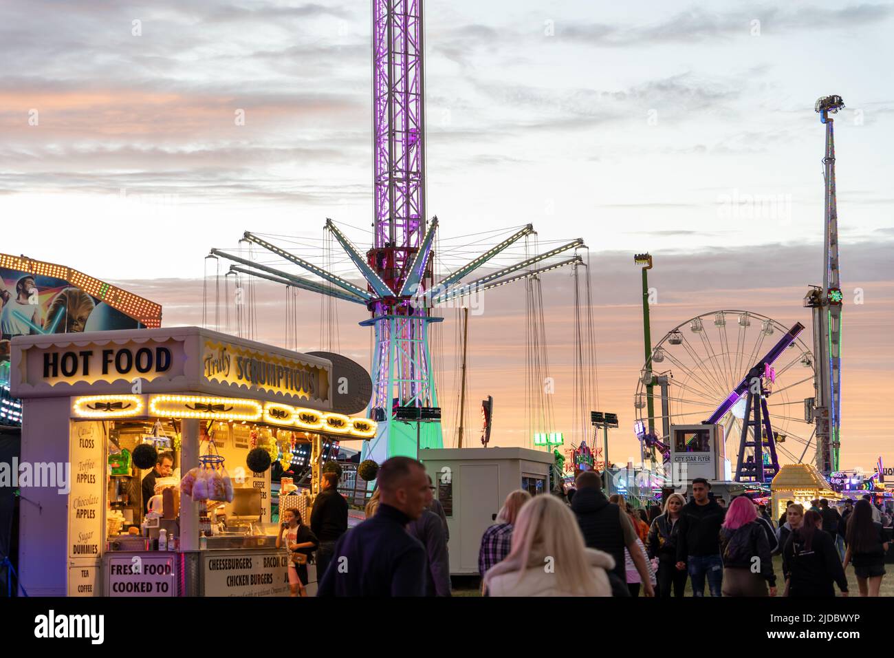 People spending leisure time at the funfair. The 140th 'Hoppings' on the Town Moor, Newcastle upon Tyne, UK. Stock Photo