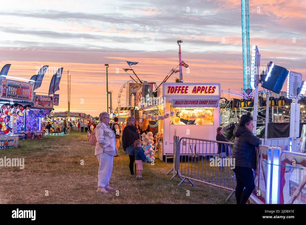People spending leisure time at the funfair. The 140th 'Hoppings' on the Town Moor, Newcastle upon Tyne, UK. Stock Photo