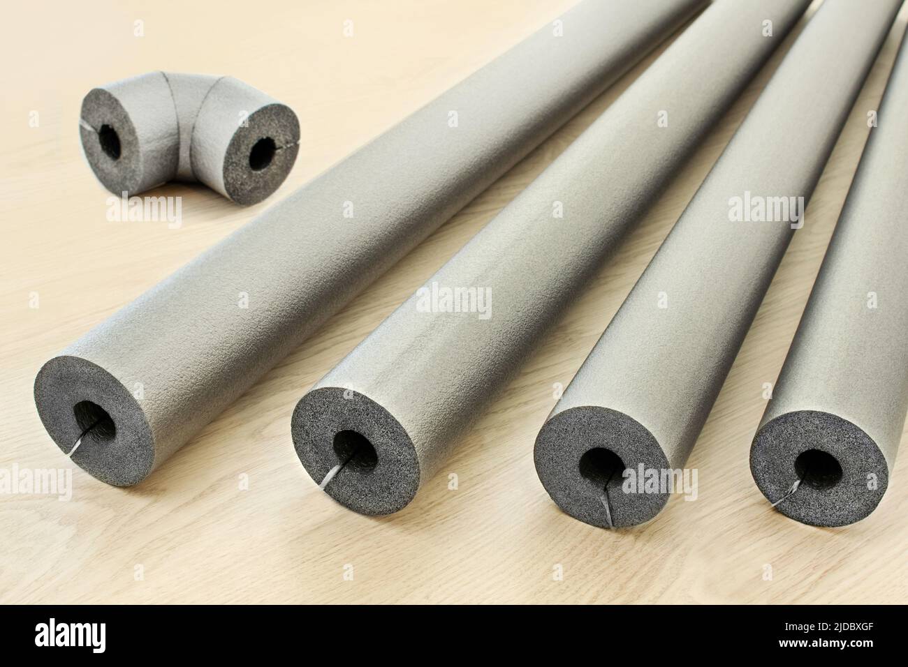Water pipe and heating pipe insulation on white background closeup