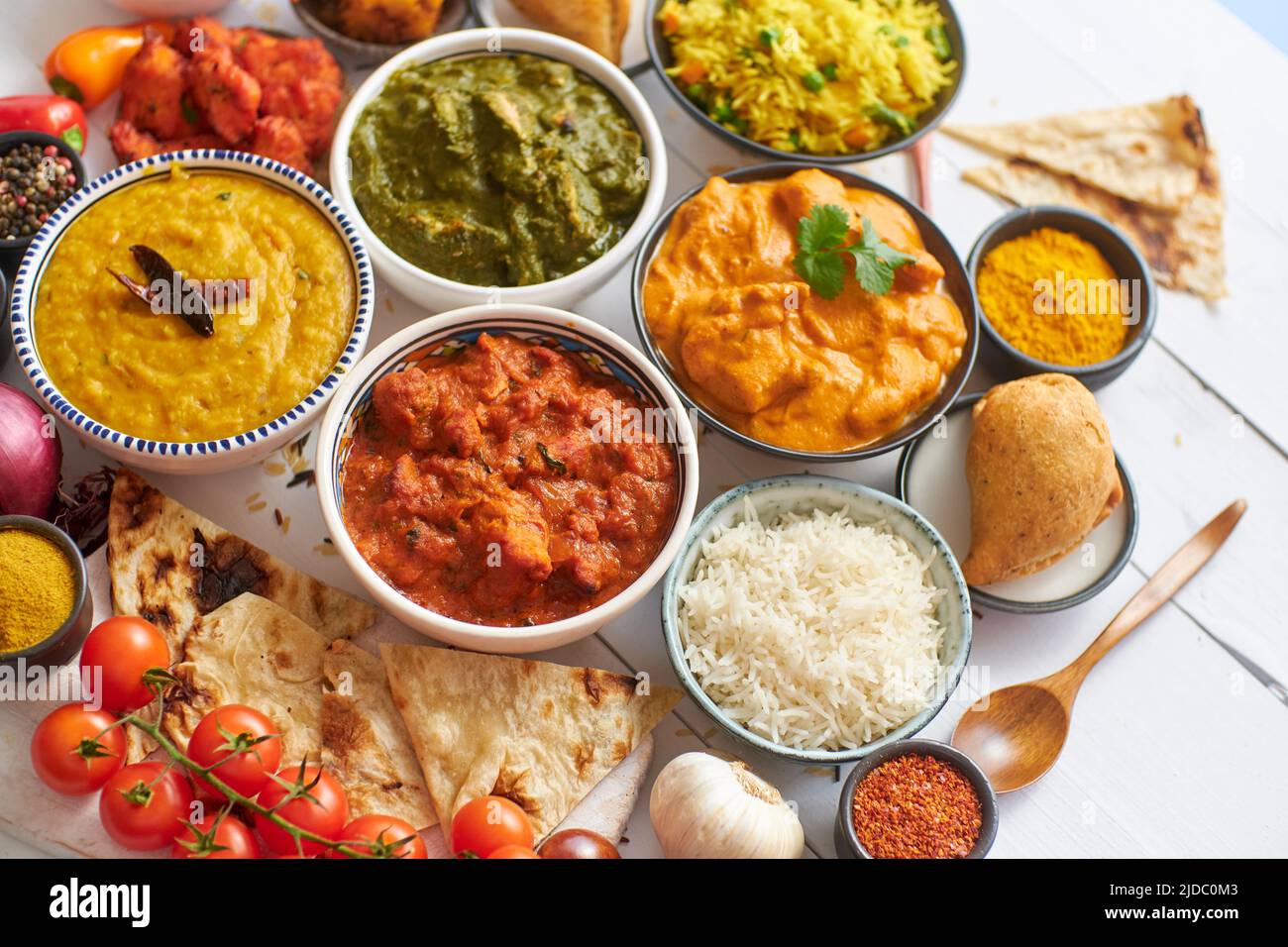 Assorted Indian various food with spices, rice and fresh vegetables