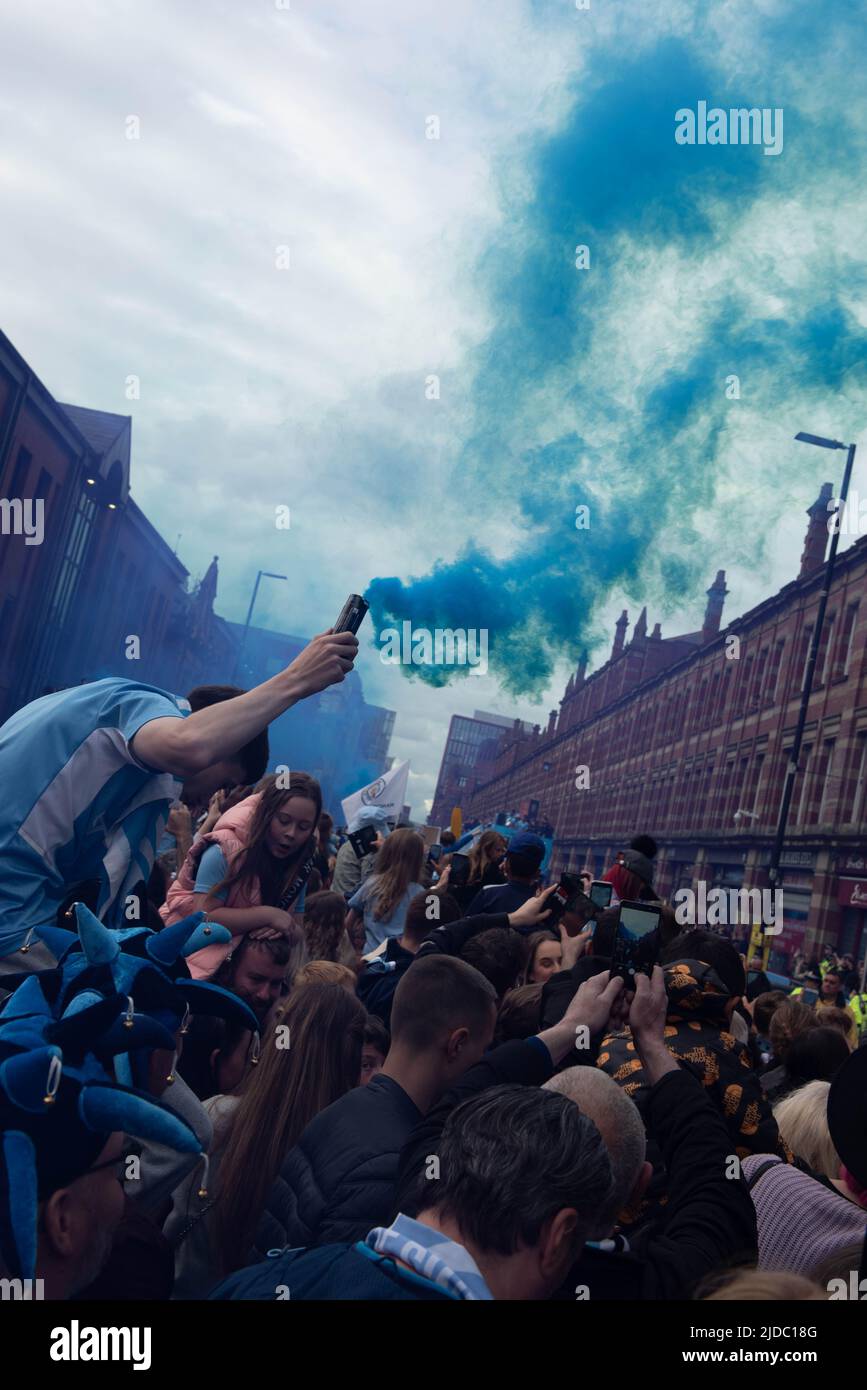 Crowds of fans celebrate Manchester City winning 4 Premier League titles in 5 years with an open top bus parade through the streets of Manchester Stock Photo