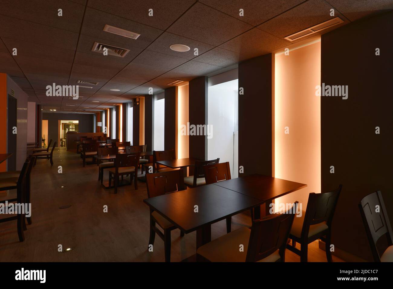 Dining room of a restaurant with wooden tables matching the chairs and