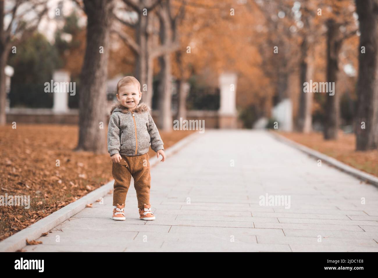 Cute baby girl 12 year old wear jacket with hood and pants walk in