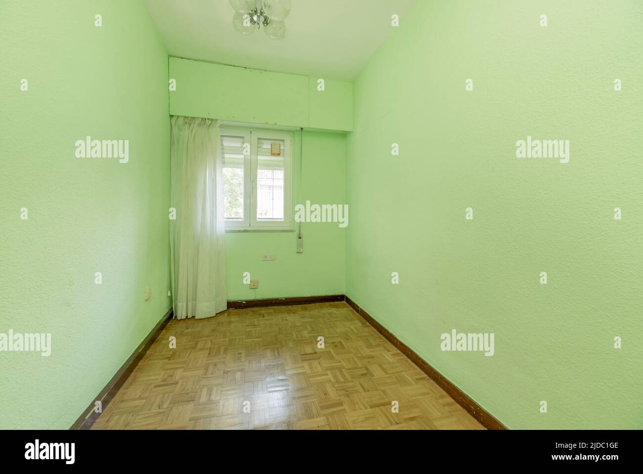 Empty room with light green painted walls and curtain with white curtains Stock Photo