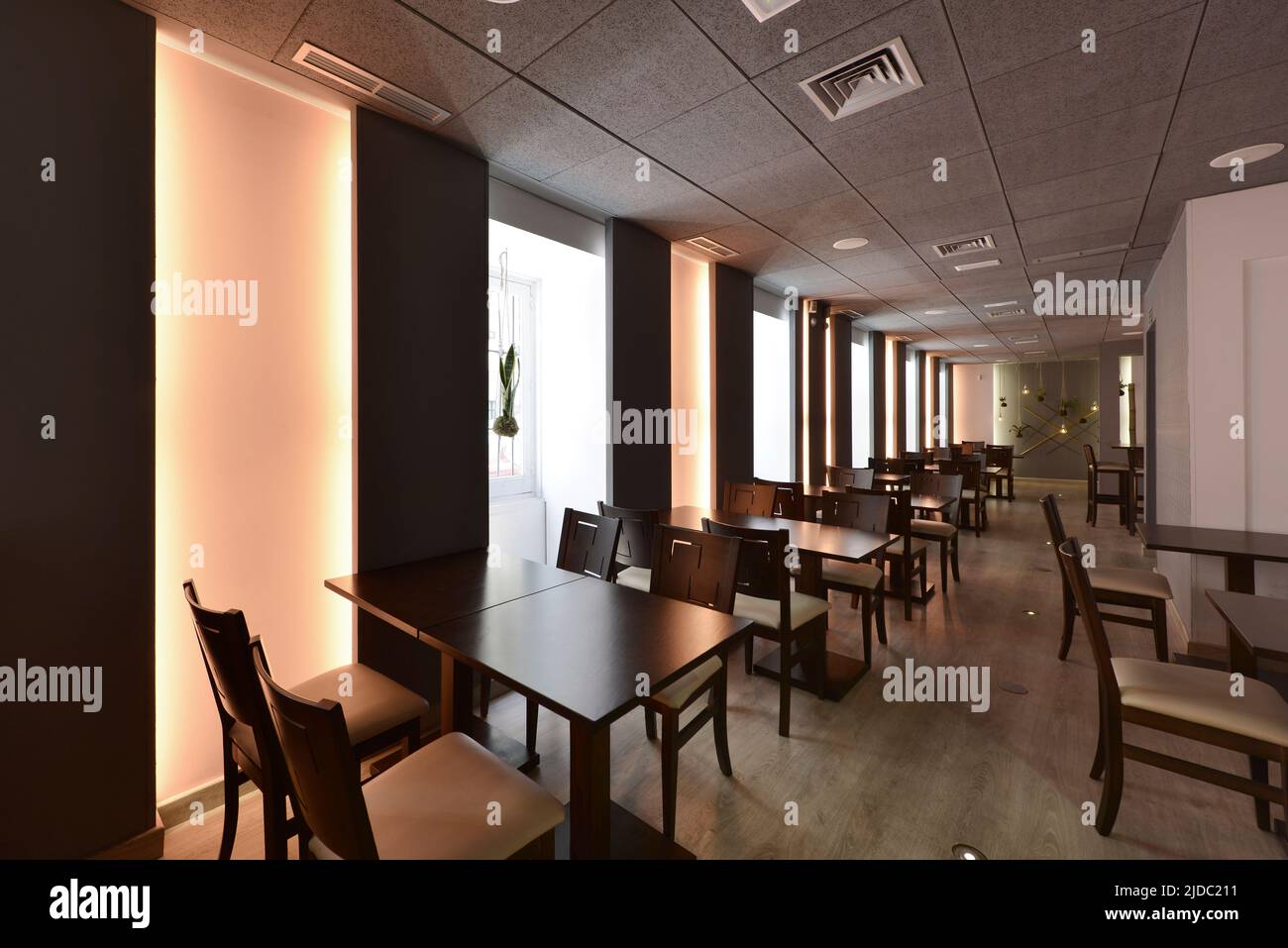 Dining room of a restaurant with a dark wood table, matching chairs and
