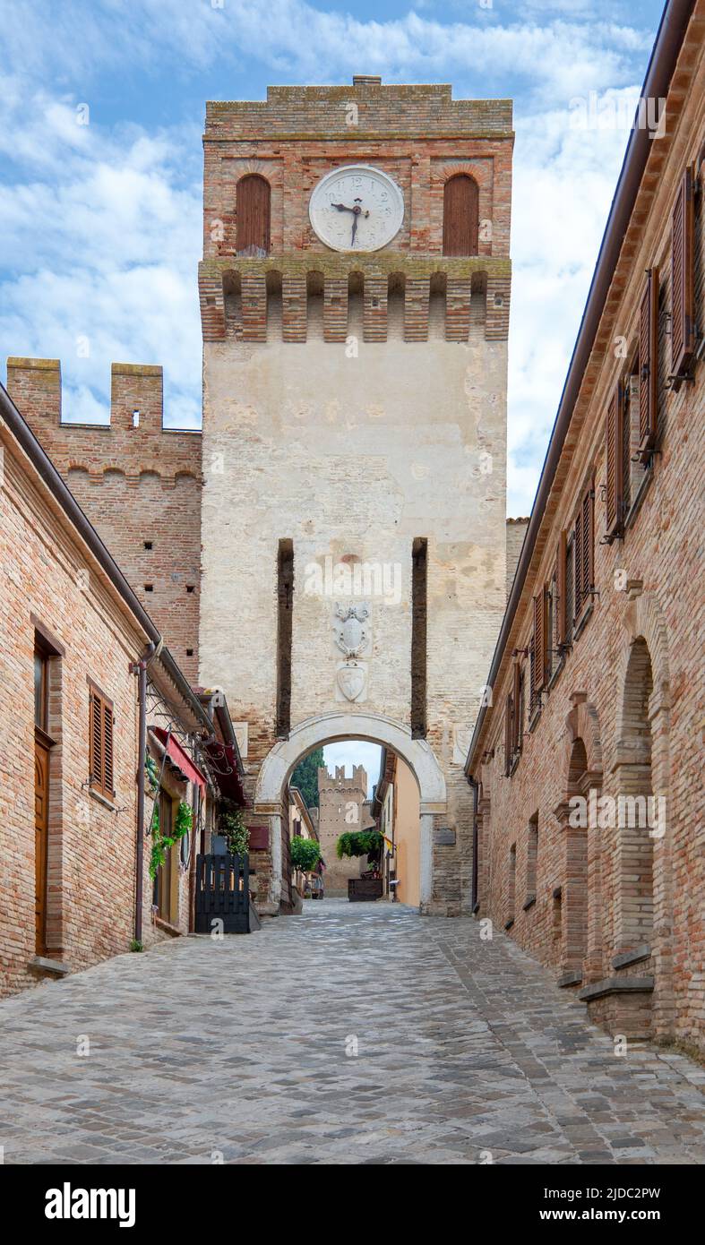 Gradara, Italy, view of the Firau tower with clock, ancient entrance to the medieval village Stock Photo