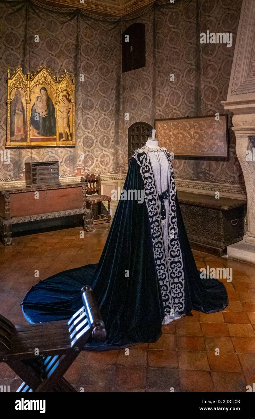 Gradara, Italy - May 29, 2018: The Francesca's bedroom with a wonderful dress of the time in the Malatesta Fortress Stock Photo