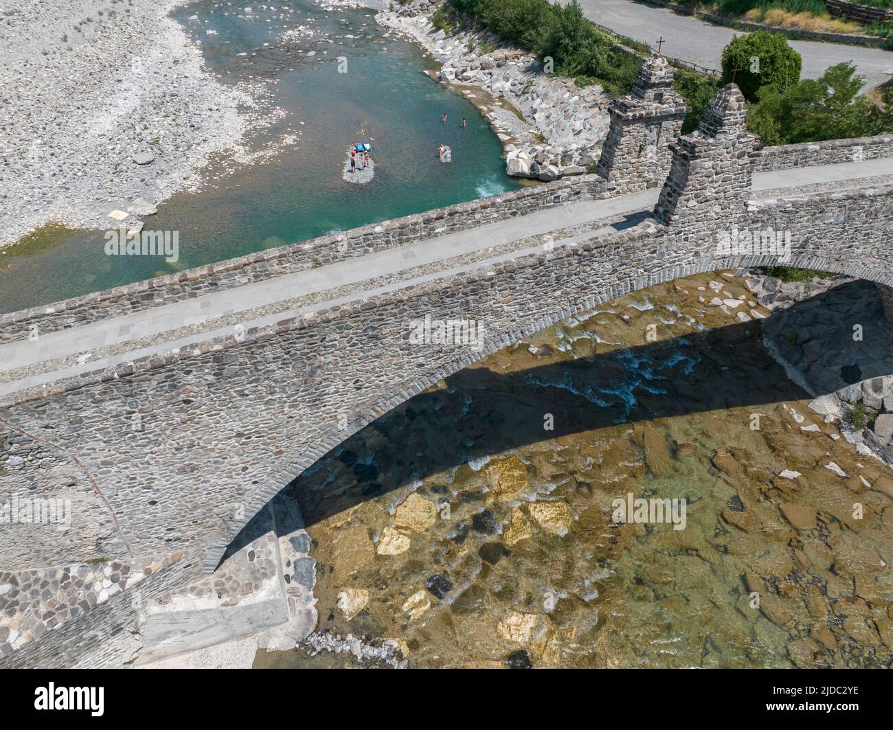Aerial view. Drought and dry rivers. Roman bridge of Bobbio over the Trebbia river, Piacenza, Emilia-Romagna. Italy. 06-16-2022. River bed with stones Stock Photo