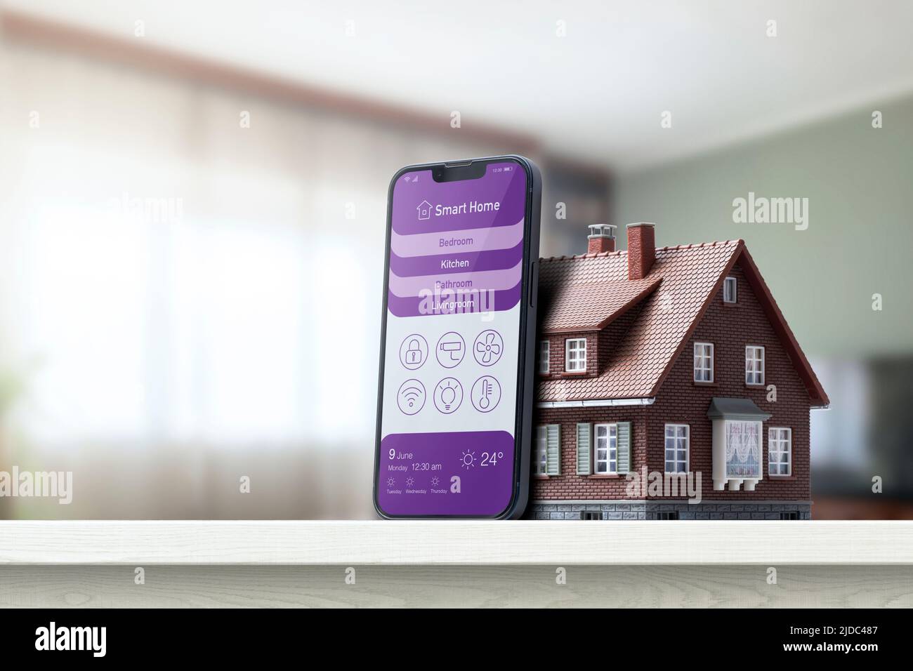 Smart home control app on smartphone and model house, home automation ...