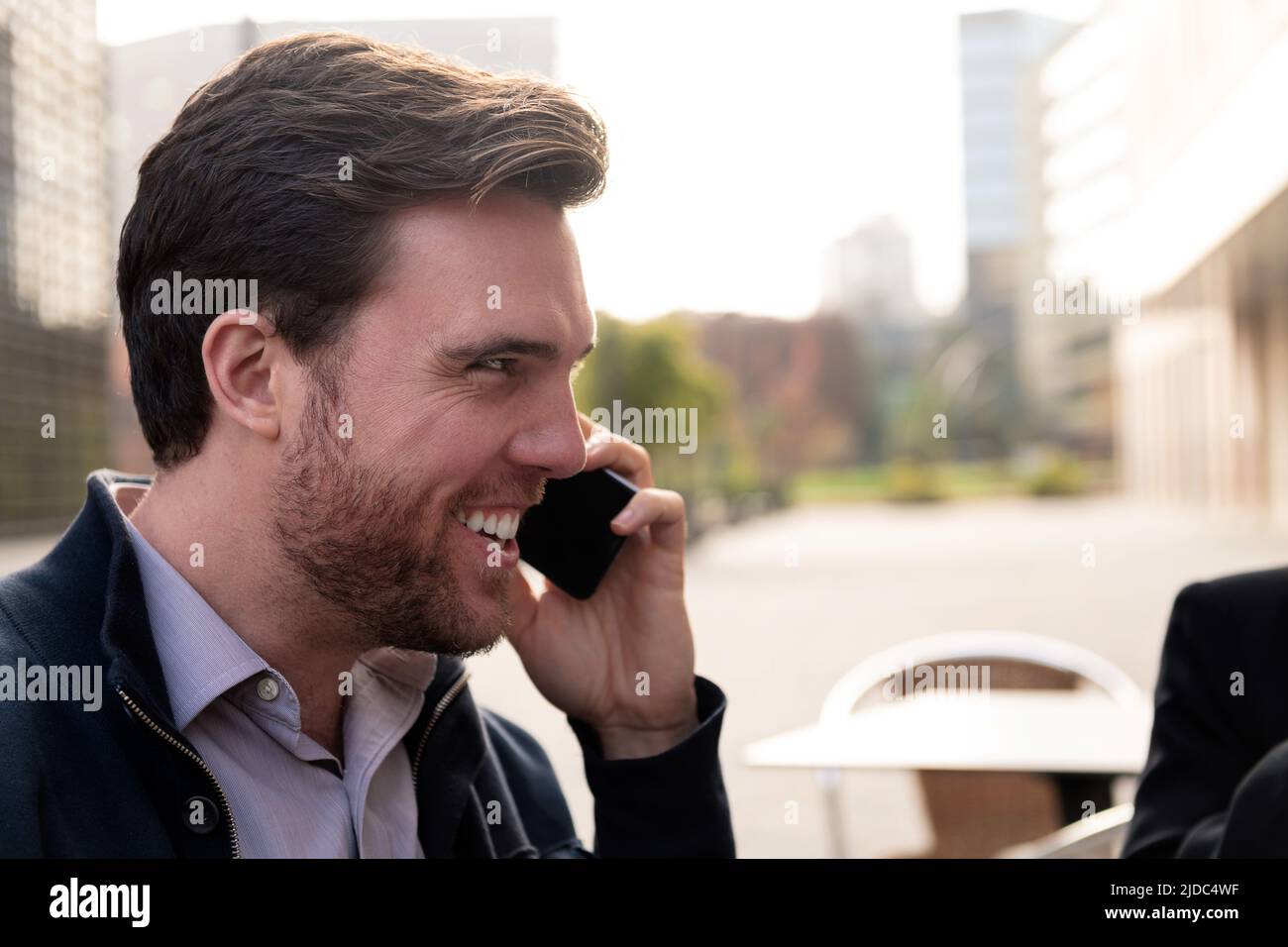 smiling businessman talking by phone Stock Photo