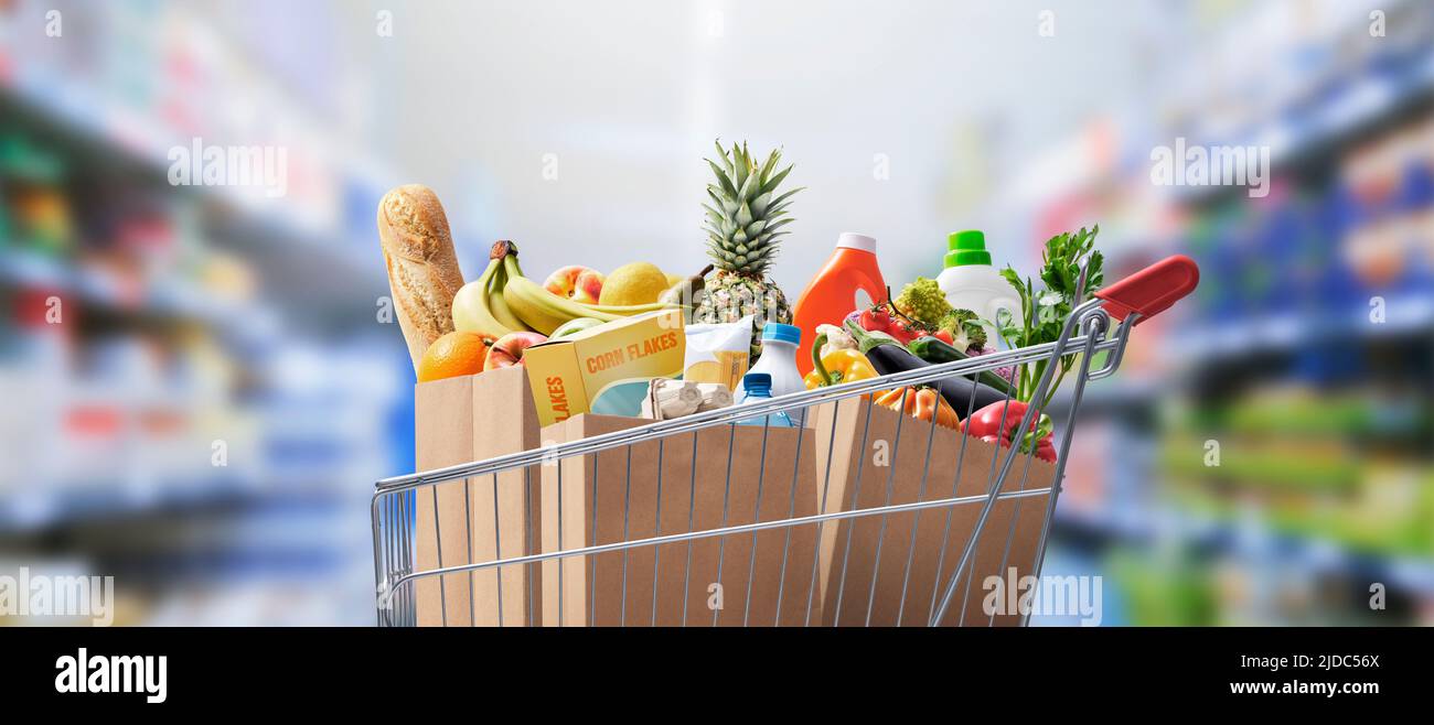 Shopping cart full of groceries at the supermarket Stock Photo Alamy