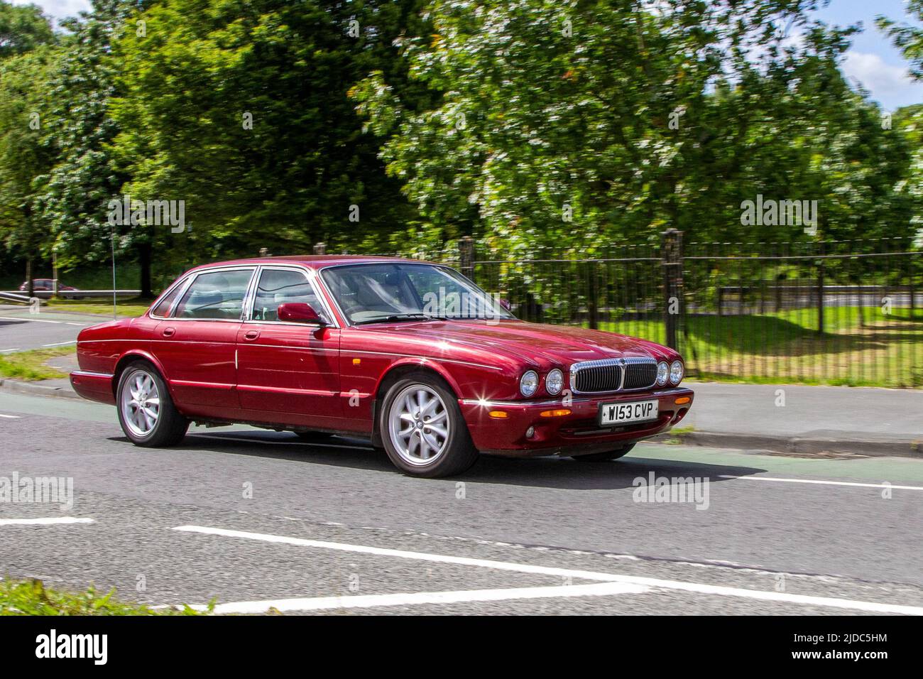 2000 red British Jaguar XJ XJ8 3248cc 5 speed automatic 4dr sedan; automobiles featured during the 58th year of the Manchester to Blackpool Touring Assembly for Veteran, Vintage, Classic and Cherished cars. Stock Photo