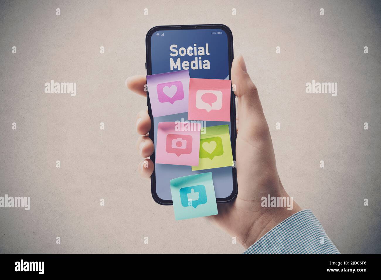 Woman connecting with social media online: sticky notes with icons on smartphone screen, POV shot Stock Photo