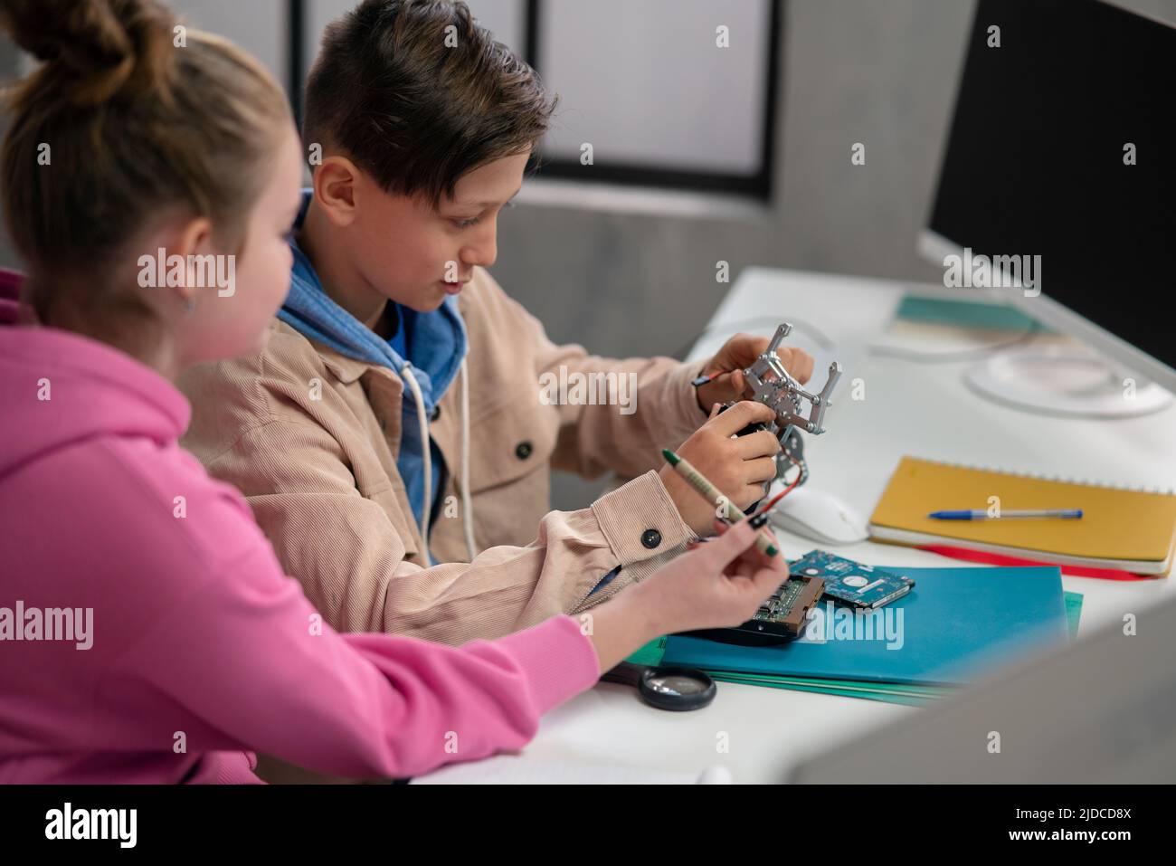 Pupils at school working with electronics component at robotics