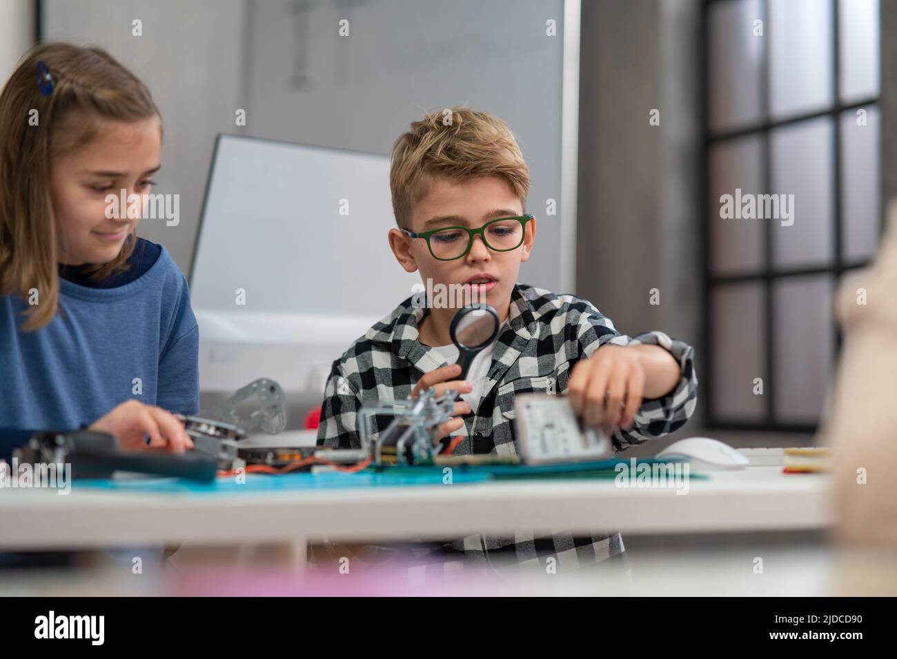 Pupils at school working with electronics component at robotics classroom. Stock Photo