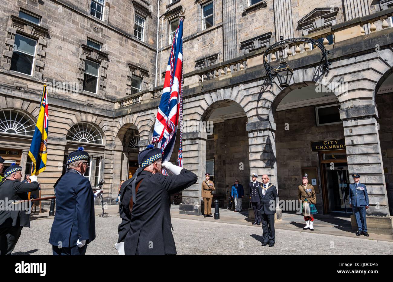 City Chambers, Edinburgh, Scotland, United Kingdom, 20 June 2022. Armed Forces flag raising ceremony: A procession with Armed Forces Day flag is met by Lord Provost Robert Aldridge at City Chambers with a Parade Marshall, standard bearers & Eddie Maley carrying the flag plus guests Lt Cdr Will McLeman (Royal Navy) Garrison Commander Lt Col Lorne Campbell (British Army) & Squadron Leader Derek Read (Royal Air Force). The Flag Raising Ceremony is a national event to honour Armed Forces personnel Stock Photo
