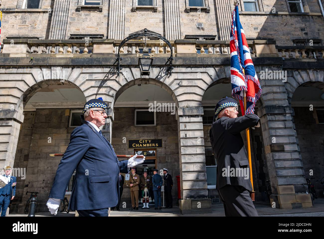 City Chambers, Edinburgh, Scotland, United Kingdom, 20 June 2022. Armed Forces flag raising ceremony: A procession with Armed Forces Day flag led by piper LSgt Macrae (Scots Guards Pipes & Drums) at City Chambers with a Parade Marshall,. The Flag Raising Ceremony is a national event to honour Armed Forces personnel Stock Photo