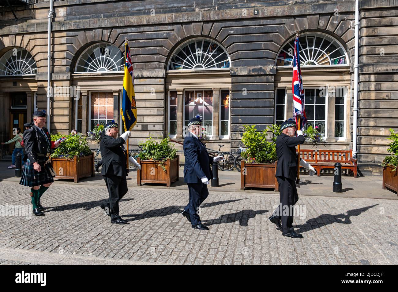 City Chambers, Edinburgh, Scotland, United Kingdom, 20 June 2022. Armed Forces flag raising ceremony: A procession with Armed Forces Day flag at City Chambers with a Parade Marshall, standard bearers & Eddie Maley carrying the flag plus guests Lt Cdr Will McLeman (Royal Navy) Garrison Commander Lt Col Lorne Campbell (British Army) & Squadron Leader Derek Read (Royal Air Force). The Flag Raising Ceremony is a national event to honour Armed Forces personnel Stock Photo