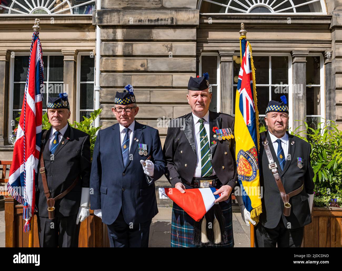 City Chambers, Edinburgh, Scotland, United Kingdom, 20 June 2022. Armed Forces flag raising ceremony: A procession with Armed Forces Day flag at City Chambers with a Parade Marshall and standard bearers. The Flag Raising Ceremony is a national event to honour Armed Forces personnel. Pictured: Legion Scotland Parade Marshall (Tommy Hermiston), standard bearers (Paul Cooper and David Cutler) and Eddie Maley, who will carry the flag Stock Photo