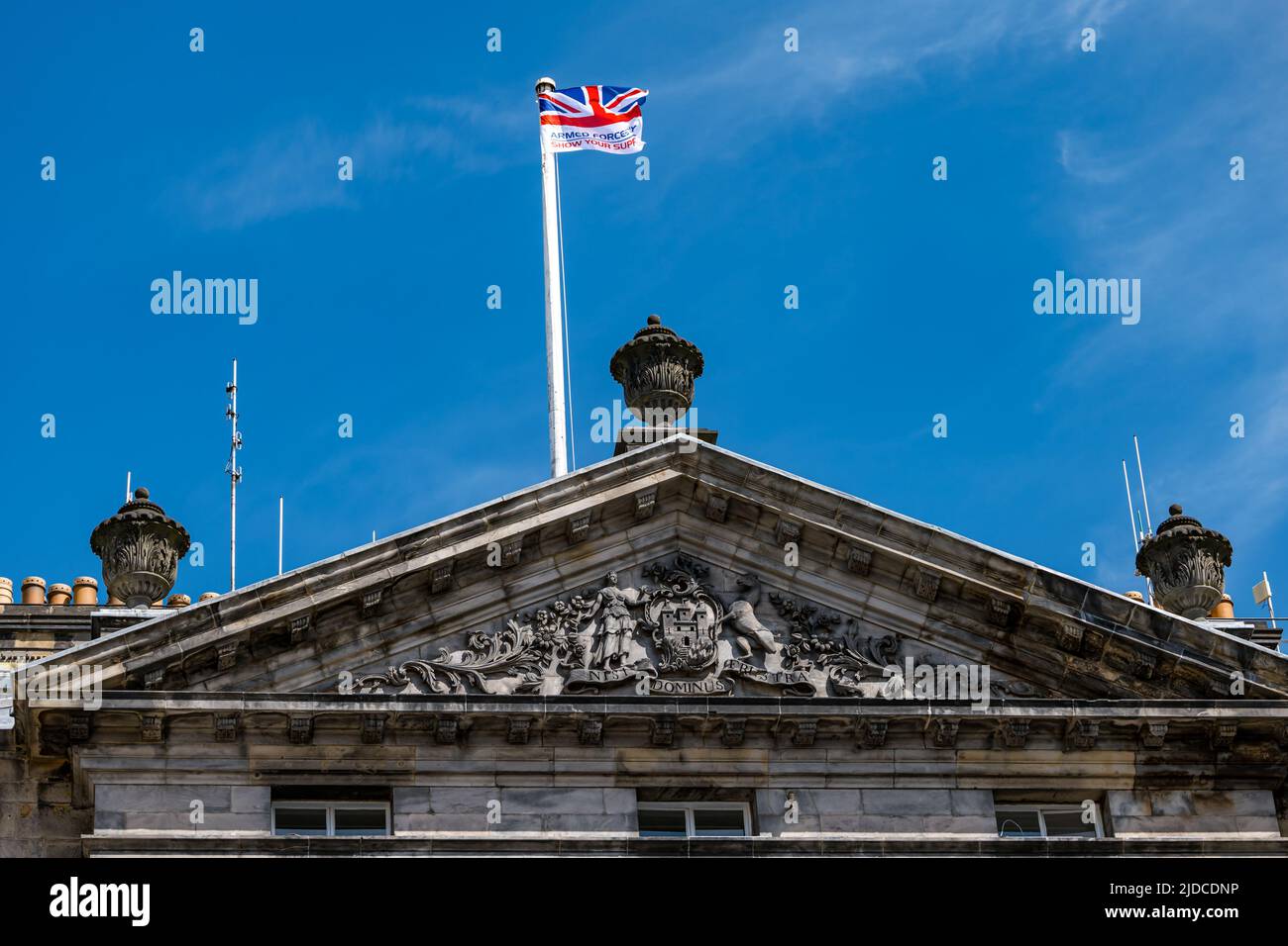 City Chambers, Edinburgh, Scotland, United Kingdom, 20 June 2022. Armed Forces flag raising ceremony: A procession with Armed Forces Day flag. The Flag Raising Ceremony is a national event to honour Armed Forces personnel. Pictured: the flag is raised above City Chambers Stock Photo