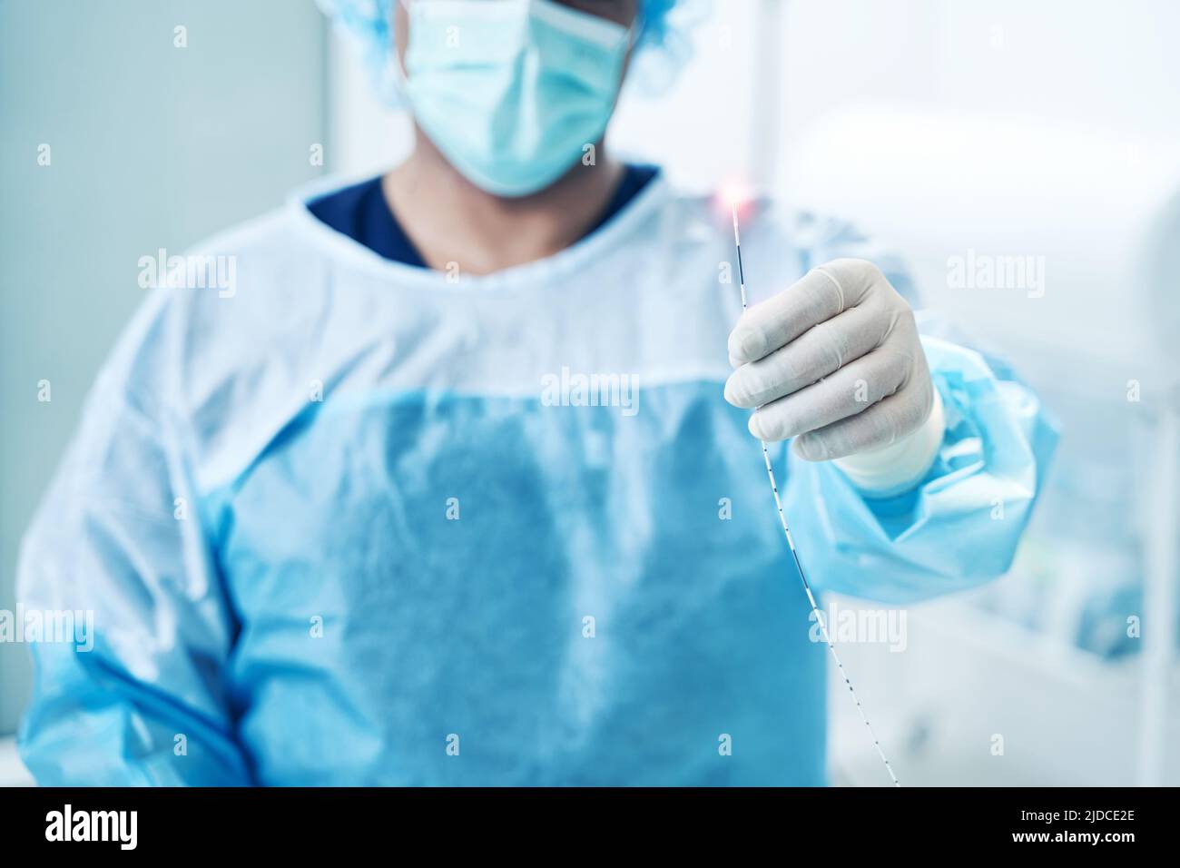 Doctor in medical clothes showing laser treatment instrument Stock