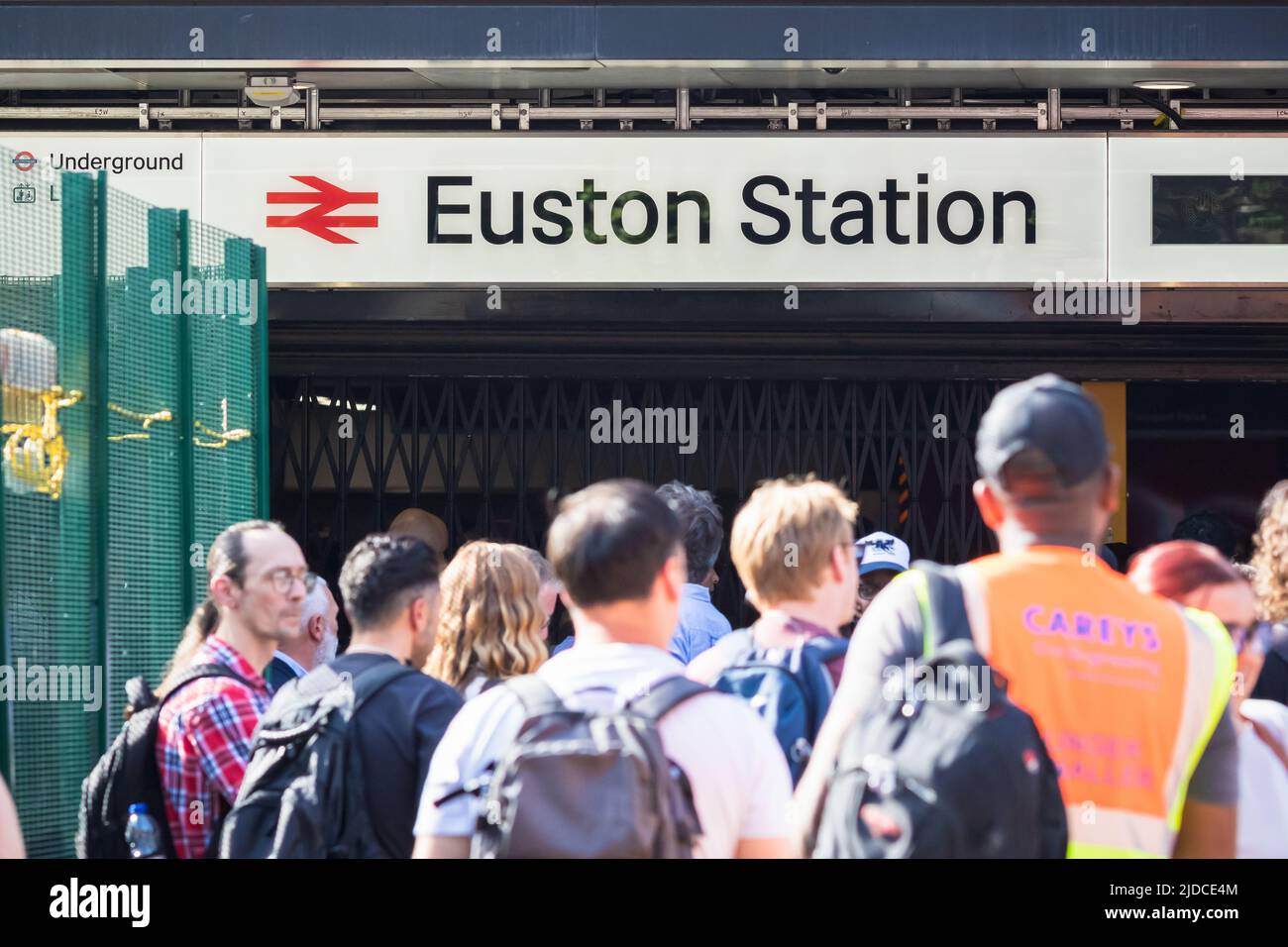 London, UK - 17 June, 2022 - Crowd of train passengers forced to wait outside the Euston Station due to temporary service closure Stock Photo