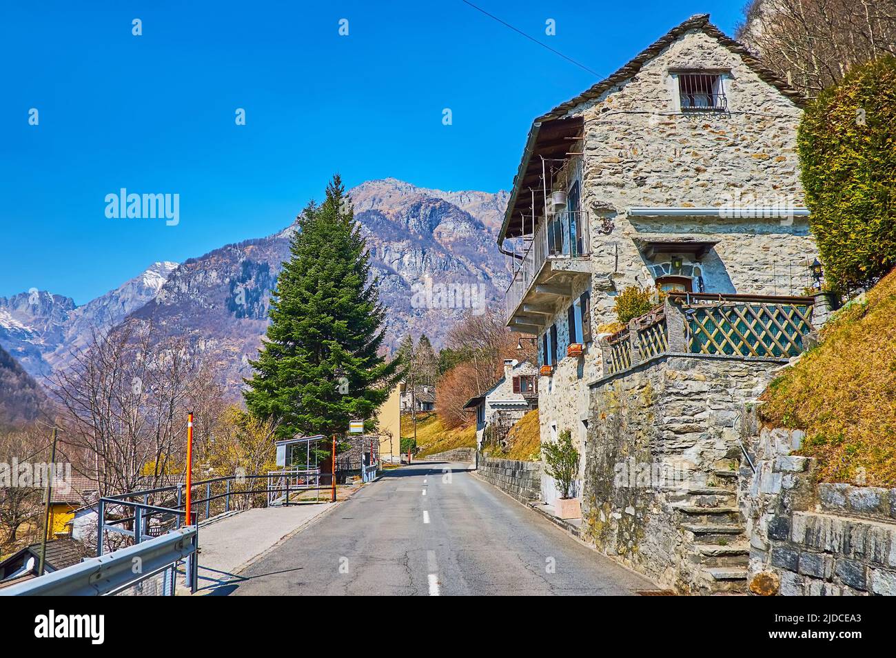 The picturesque rocky Lepontine Alps are seen behind the houses of Frasco, Valle Verzasca, Switzerland Stock Photo