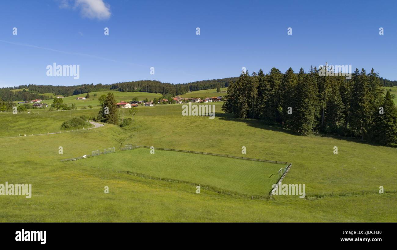 Aerial shot of a soccer field in the Allgäu with a stream as a side line Stock Photo