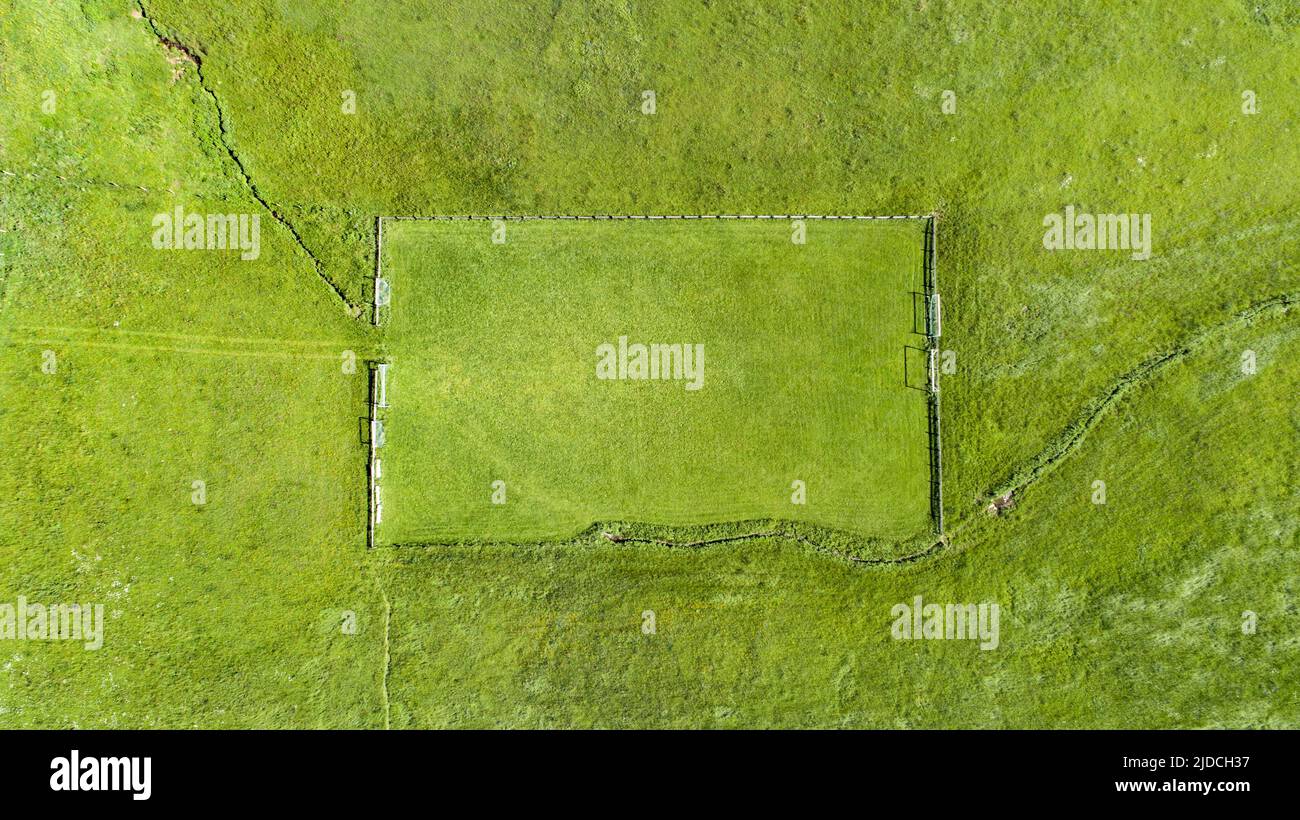 Aerial shot of a soccer field in the Allgäu with a stream as a side line Stock Photo