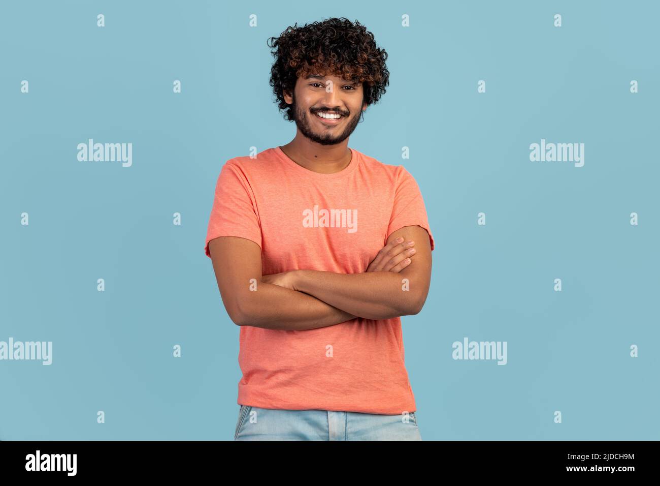 Cheerful handsome young eastern man on blue Stock Photo